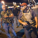 Oath Keepers, carrying rifles, walk along West Florissant Avenue in Ferguson, Mo., as demonstrators, marking the first anniversary of the fatal shooting of Michael Brown, protest Aug. 10, 2015.
Scott Olson/Getty Images